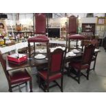 A long dark oak draw leaf table and 6 chairs with red leather panels (collect only).