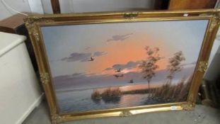 A gilt framed oil on canvas lake scene signed G Brahwer.