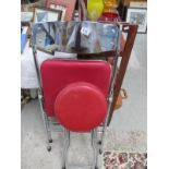 A chromed metal seat and a stool