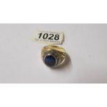 A yellow metal ring (tests as 18ct gold) 14.9 grams with stones, size V.
