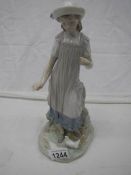 A Lladro figure of a girl feeding birds, 29cm.