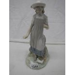 A Lladro figure of a girl feeding birds, 29cm.