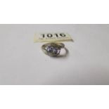 A diamond and tanzanite three stone ring with diamond shoulders in 9ct gold. Size N.