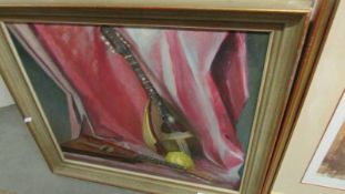 A Marion Lewin (20th century British School) framed oil on board still life painting with musical