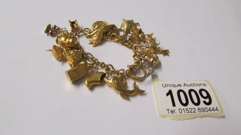 A 9ct gold charm bracelet with charms, 34 grams. (re-entered due to non paying bidder).