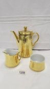 A Royal Worcester gilded coffee pot, sugar bowl and cream jug.