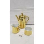 A Royal Worcester gilded coffee pot, sugar bowl and cream jug.