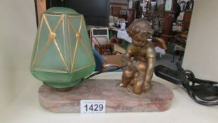 A French spelter cherub on marble table lamp with original glass shade.