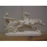 A white statue of a chariot with charioteer and two horses