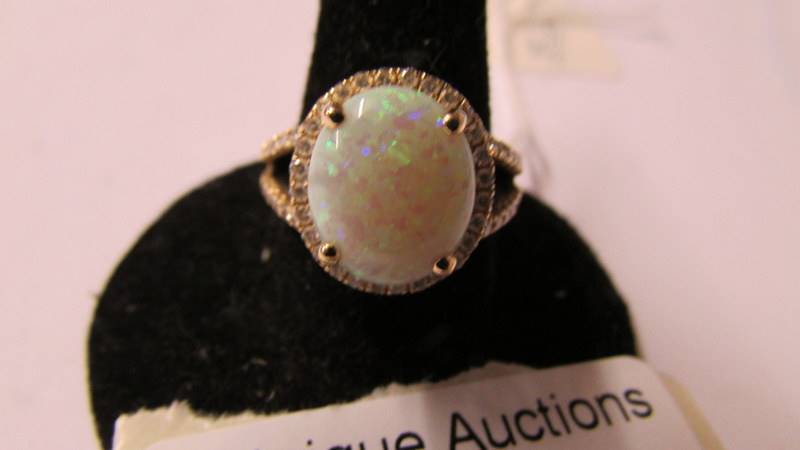 A 14k gold ring set small diamonds and central opal (approx. 10mm x 12mm), size N. - Image 2 of 2