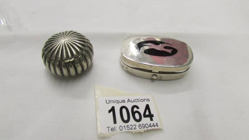A silver pill box with seagull design and an interesting white metal pill box.