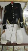 A dress uniform and a white uniform jacket.