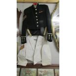 A dress uniform and a white uniform jacket.