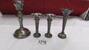 A pair of small hall marked silver spills, a single silver spill and a single silver candlestick.