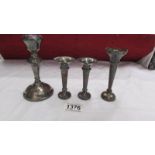 A pair of small hall marked silver spills, a single silver spill and a single silver candlestick.