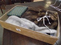 A fur jacket in origjnal box, a fur stole, a small evening bag and hatpins.