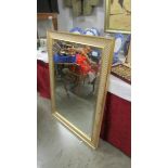 A large framed bevel edged mirror.