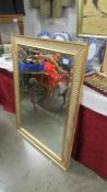 A large framed bevel edged mirror.