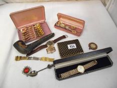An interesting tray of watches, spoons, badges etc.