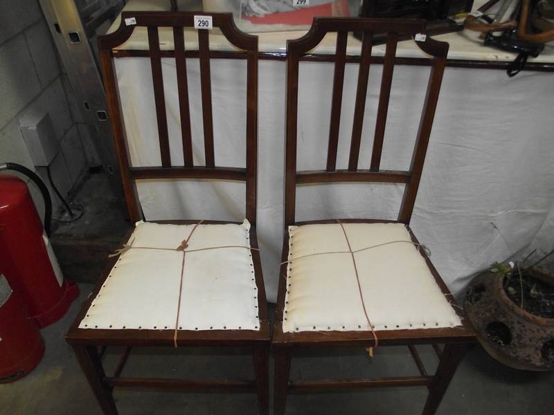 A pair of Edwardian hall chairs.