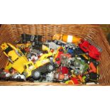 A wicker basket of die cast and plastic vehicles.