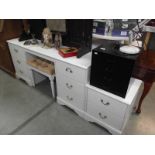 4 pieces of white bedroom furniture including 2 chests and a dressing table.