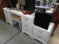 4 pieces of white bedroom furniture including 2 chests and a dressing table.