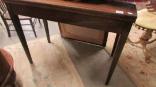 A mahogany fold over table.