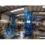 2 large blue glass jugs,