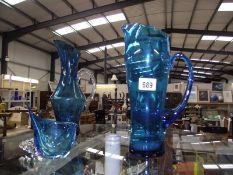 2 large blue glass jugs,