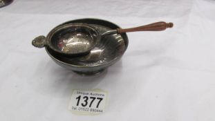 A hall marked silver dish and a hall marked silver tea strainer.