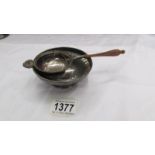 A hall marked silver dish and a hall marked silver tea strainer.