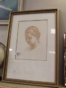 A framed and glazed print of a girls head Musee De Louvre
