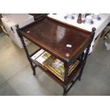 A 1930's oak tea trolley with drawer on barley twist legs.