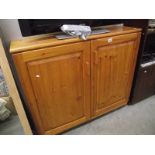 A solid pine 2 door cupboard