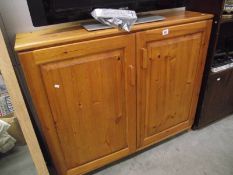 A solid pine 2 door cupboard