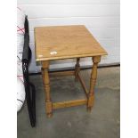 A polished light oak side table.