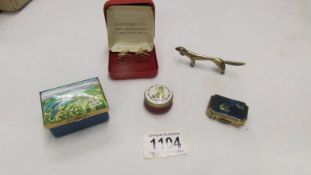 A Bilston enamel pill box, a Stratton pill box, one other,