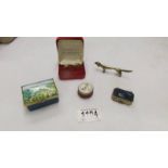 A Bilston enamel pill box, a Stratton pill box, one other,