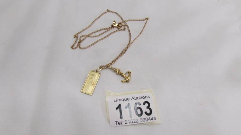 A 14k gold pendant of Madonna & Child on chain with unmarked anchor, total weight 7.5 grams.