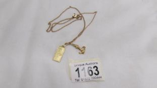 A 14k gold pendant of Madonna & Child on chain with unmarked anchor, total weight 7.5 grams.