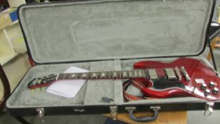 A Epiphone SG Pro electric guitar 'Cherry' left hand with hard case, in good condition with strap,