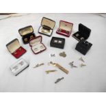 13 pairs of cuff links and 4 tie pins.