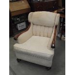 An Edwardian wing arm chair.