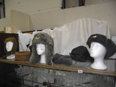 A quantity of military hats including tank drivers, Russian fur etc.