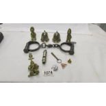 A mixed lot of police related items including hand cuffs, police helmet bells, door knocker,