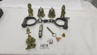 A mixed lot of police related items including hand cuffs, police helmet bells, door knocker,