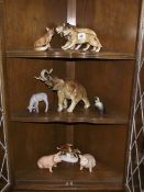 8 ceramic animal figurines including lions, elephant etc.