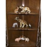 8 ceramic animal figurines including lions, elephant etc.