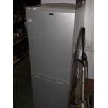 A silver coloured fridge freezer.